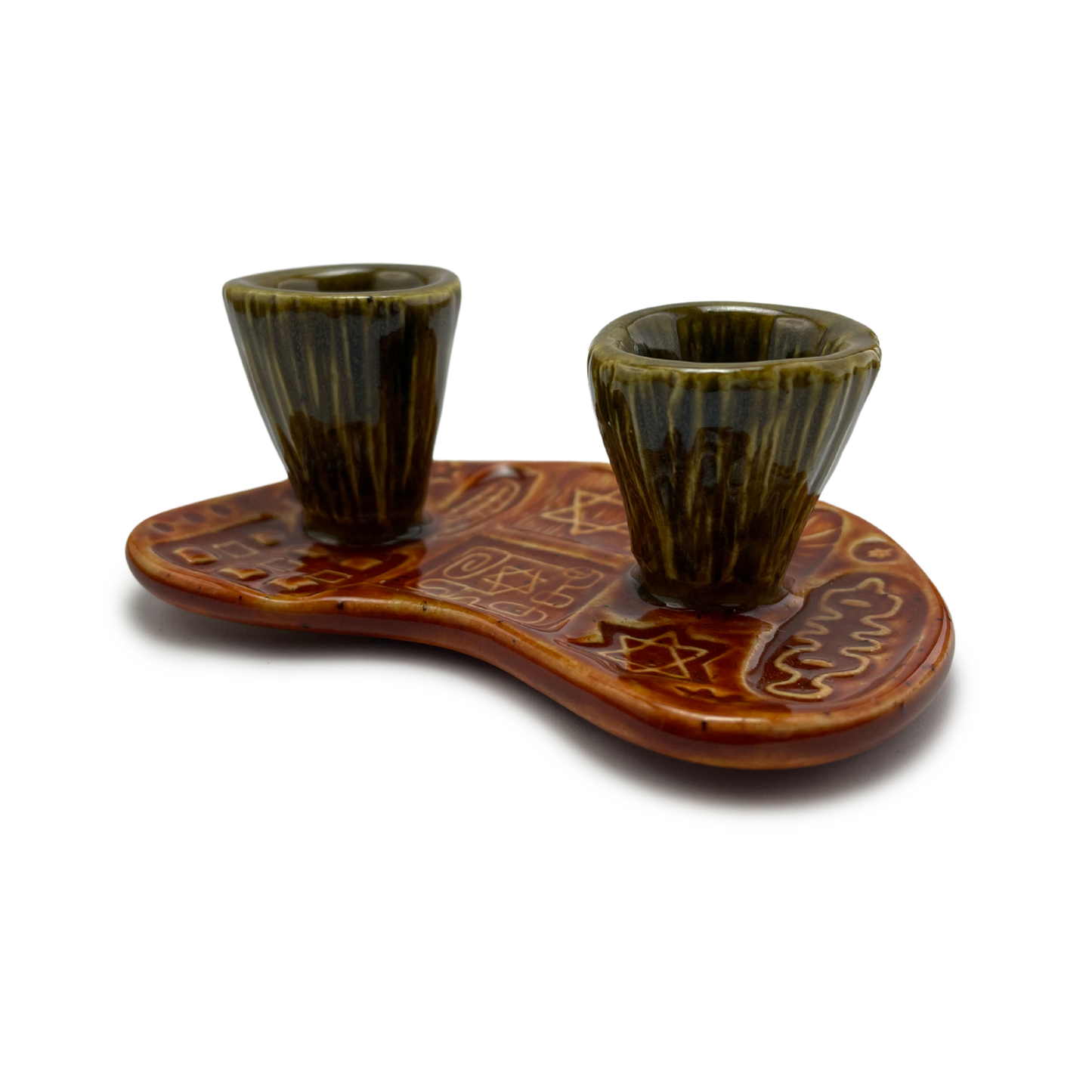 Jewish pottery shabbat candle holder for candlesticks, ceramic handmade sabbath day candle stand holder for jewish sabbath, handmade pottery for judaism shabbat judaica store and jewish gifts. Handcrafted jewish art by judaica artist Shana Ostrowiecki in California, made in the usa. Handpainted and one of a kind burnt orange olive green