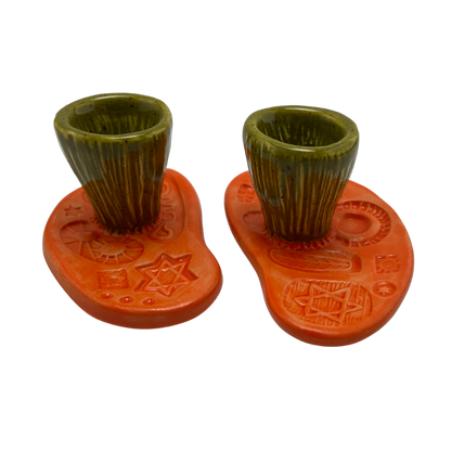 Jewish pottery shabbat candle holder for candlesticks, ceramic handmade sabbath day candle stand holder for jewish sabbath, handmade pottery for judaism shabbat judaica store and jewish gifts. Handcrafted jewish art by judaica artist Shana Ostrowiecki in California, made in the usa. handpainted and one of a kind orange green