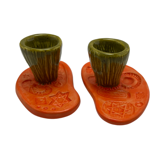 Jewish pottery shabbat candle holder for candlesticks, ceramic handmade sabbath day candle stand holder for jewish sabbath, handmade pottery for judaism shabbat judaica store and jewish gifts. Handcrafted jewish art by judaica artist Shana Ostrowiecki in California, made in the usa. handpainted and one of a kind orange green