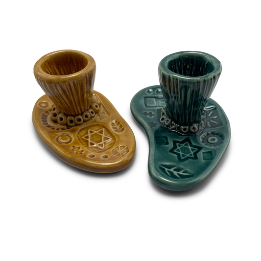 Jewish pottery shabbat candle holder for candlesticks, ceramic handmade sabbath day candle stand holder for jewish sabbath, handmade pottery for judaism shabbat judaica store and jewish gifts. Handcrafted jewish art by judaica artist Shana Ostrowiecki in California, made in the usa. Handpainted and one of a kind teal blue mustard yellow