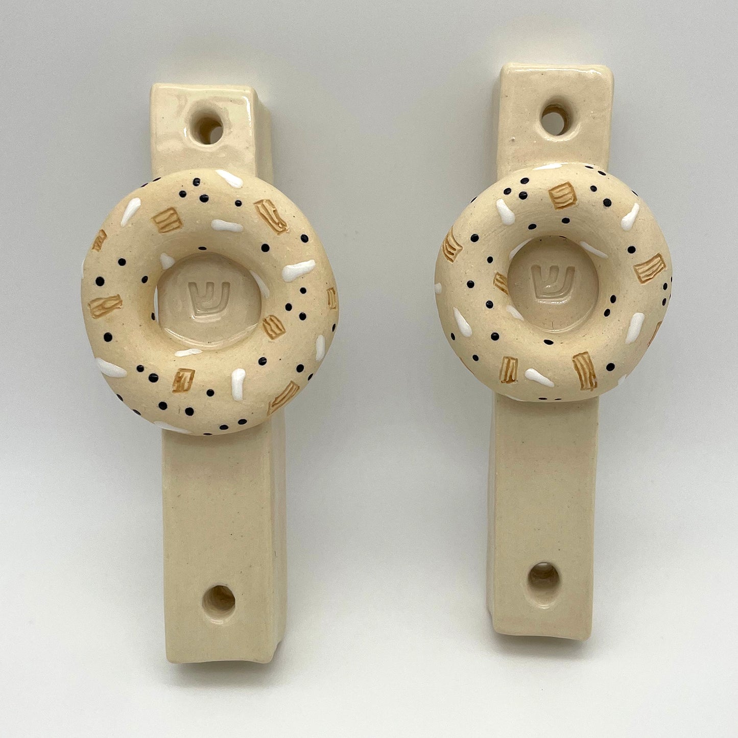 Artisan-made bagel mezuzah – a decorative and meaningful Jewish home decor item, perfect for collectors and special occasion gifts.