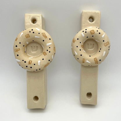Artisan-made bagel mezuzah – a decorative and meaningful Jewish home decor item, perfect for collectors and special occasion gifts.