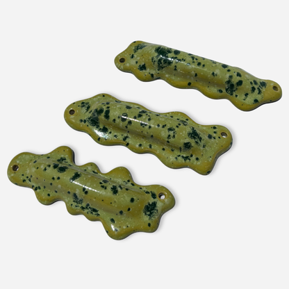 group of handmade ceramic mezuzah cases wavy blob shapes lime green sprinkle glaze judaica