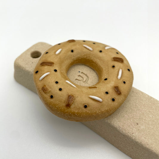 Handcrafted bagel mezuzah with ceramic texture – unique Judaica gift for Jewish home decor.