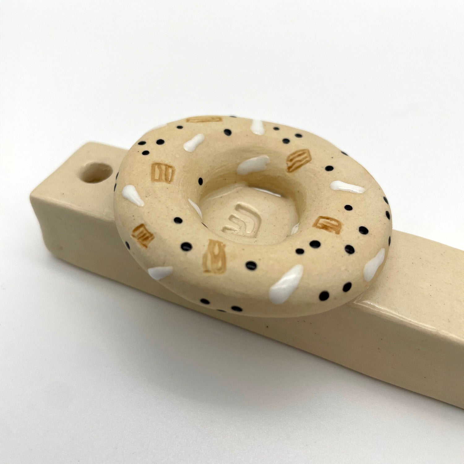 Handmade bagel mezuzah, a unique Jewish home decor piece, perfect for housewarmings, Bar Mitzvahs, or collectors of artisanal Judaica.