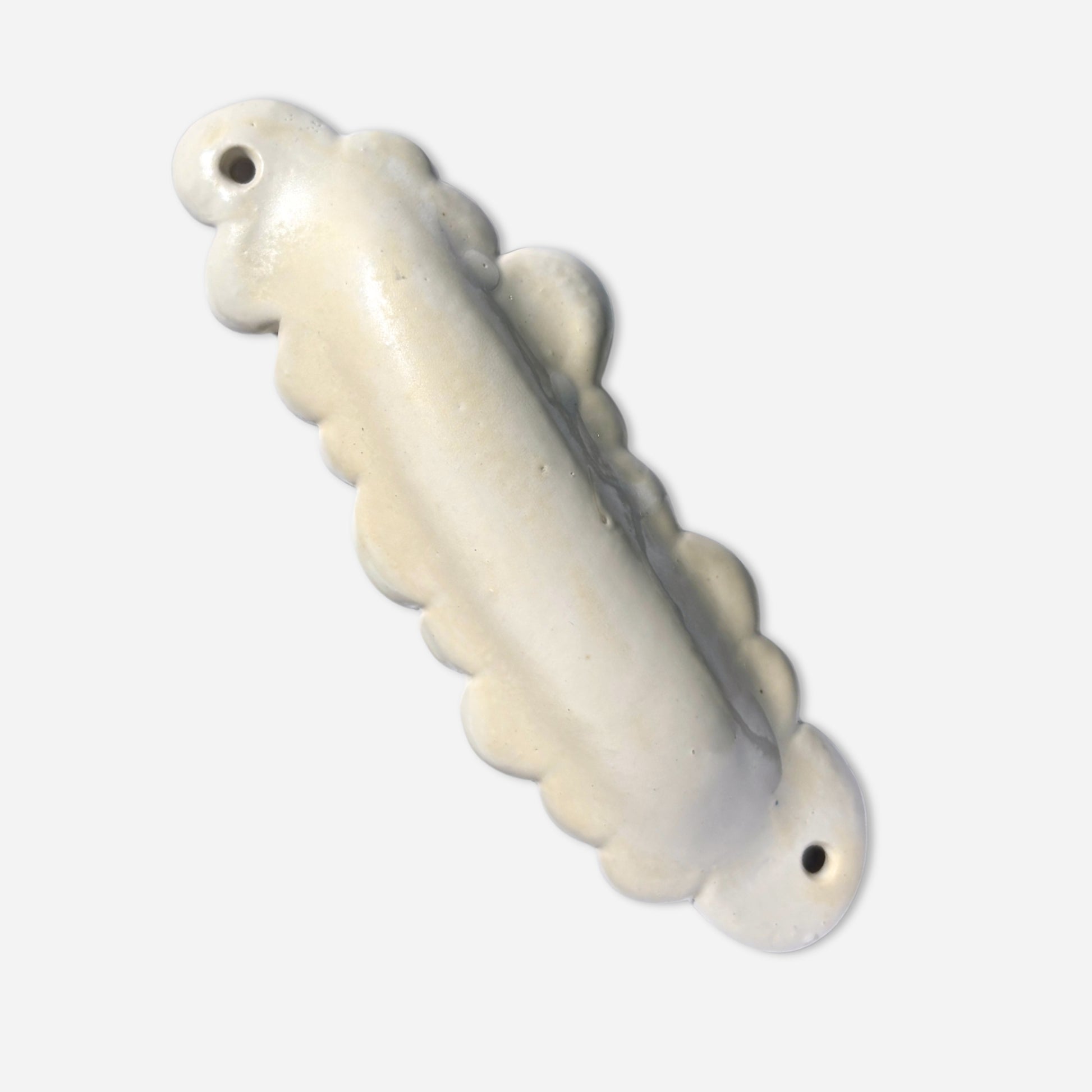 sculptural handmade mezuzah case in cloud shape with glossy finish and soft dimensional ridge