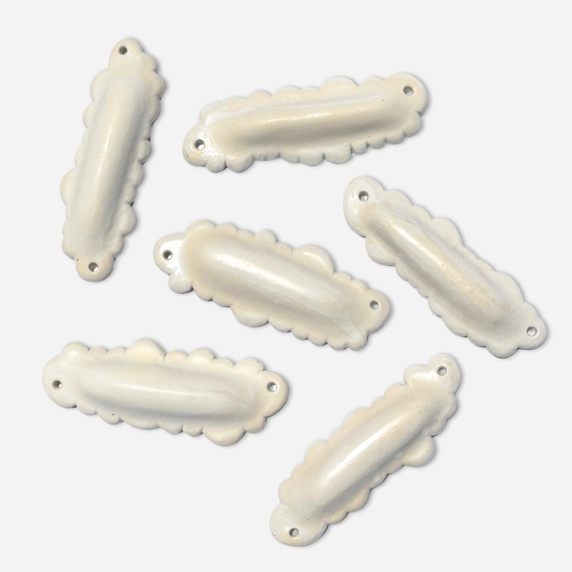 collection of sculptural ceramic mezuzah cases in cloud forms with glossy off-white finish