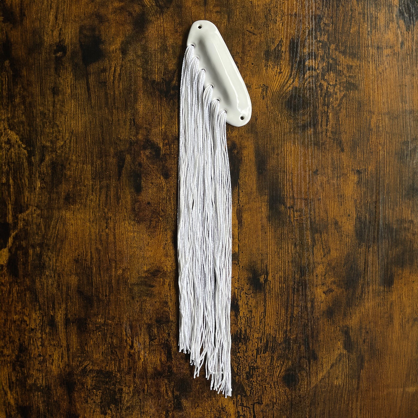 handmade mezuzah by shana ostrowiecki glazed with white gloss neutral handpainted glaze on ceramic stoneware like porcelain, textile mezuzah yarn woven into clay, fiber art judaica