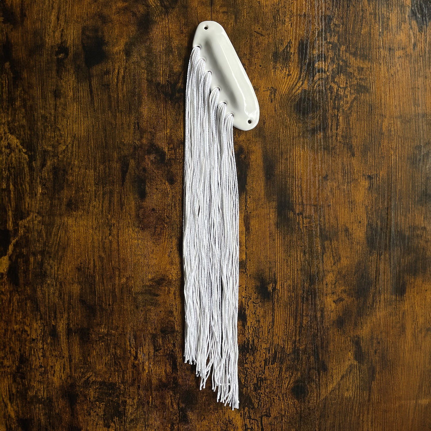 handmade mezuzah by shana ostrowiecki glazed with white gloss neutral handpainted glaze on ceramic stoneware like porcelain, textile mezuzah yarn woven into clay, fiber art judaica